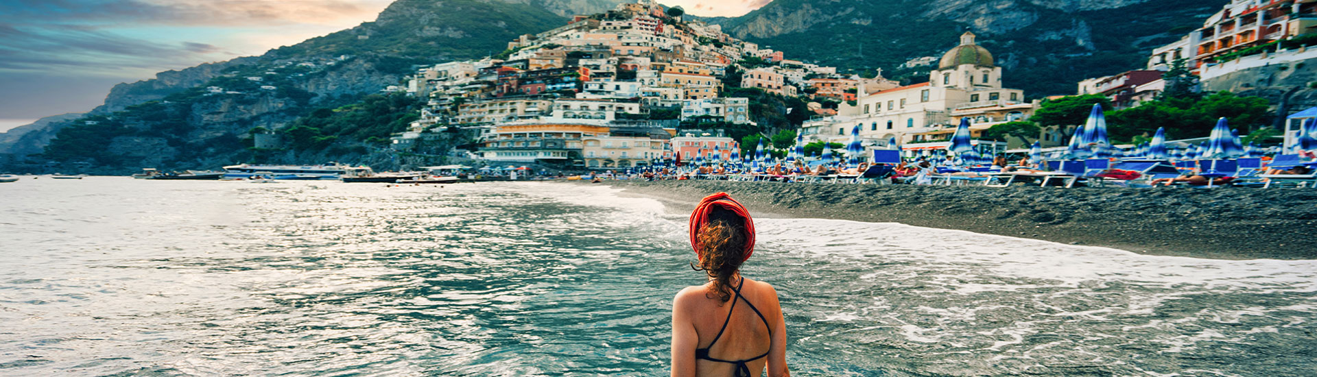 Woman wading in sea in Italy