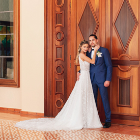Couple standing by a large wooden door