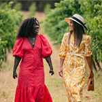 Two women walking in a vineyard